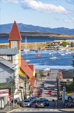 Yellow-red church in a steep street, boats in the harbour at the Beagle Channel, Ushuaia, Tierra