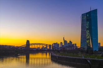 Evening atmosphere at the European Central Bank (ECB) with skyline behind the Deutschherrnbruecke