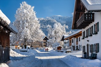 Winter village street with Heimgarten 1791m, Ohlstadt, Loisachtal, The Blue Country, Bavarian Alps,