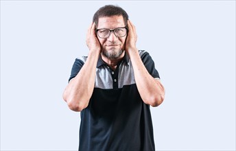 Elderly person ignoring the noise, covering ears. Displeased senior man covering his ears isolated