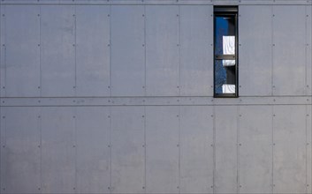 Beautiful Modern Concrete Wall with a Small Window in a Sunny Day in Switzerland