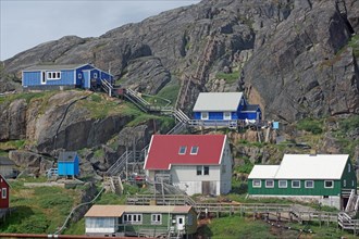 Houses connected by wooden stairs, barren mountains, Maniitsoq, Greenland, Denmark, North America