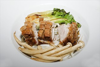 Crispy fried pork belly on Japanese udon noodles, with briefly braised pak choi and enoki