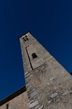 Beautiful Old Church with Bell Tower Against Blue Clear Sky in a Sunny Day in Malcantone,