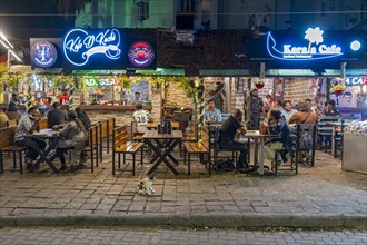 Diners enjoy a lively evening at a street-side restaurant on Tower Road, Fort Kochi, Cochin,