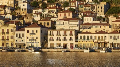 Houses and boats on the coast in the golden light of early morning, Gythio, Mani, Peloponnese,