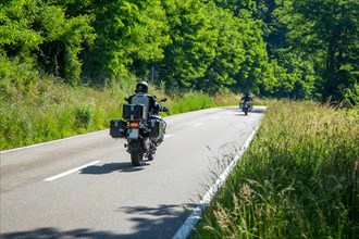 Two motorcyclists on a country road, photographed in the Palatinate Forest, Germany, Europe