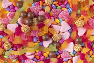 Varied mix of sweets in bright colours and chocolate, close-up, full-frame