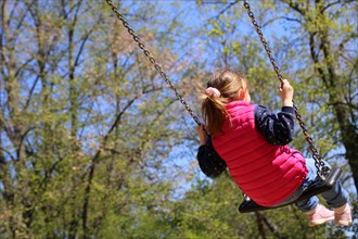Girl swinging on a playground