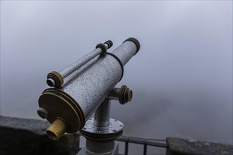 Winter atmosphere at the mountain fortress. Paying telescope with water drops, Koenigstein, Saxony,