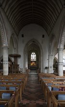 View down the nave to chancel, altar and east window inside the church at church of Saint Mary,