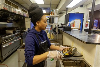 Detroit, Michigan, Natasha Coleman prepares food at Yum Village restaurant, which serves