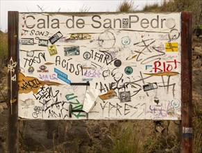 Hippy graffiti painted on noticeboard, abandoned village of Cala de San Pedro, Cabo de Gata Natural