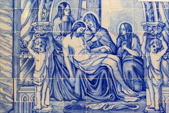 Blue and white traditional Azulejo ceramic tiles forming picture of the dead body of Jesus Christ