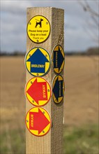 Close up of wooden post with byway and bridleway direction pointer signs, Sutton, Suffolk, England,