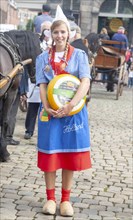 Pretty smiling girl in traditional Dutch costume, Gouda cheese market, South Holland, Netherlands