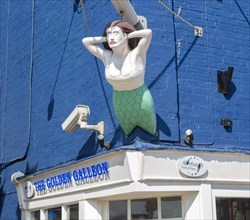 Mermaid ship's figurehead above the Golden galleon fish and chips shop, Aldeburgh, Suffolk,