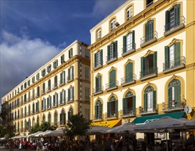 Winter evening sunshine historic facade of buildings, Plaza de la Merced, Malaga, Andalusia, Spain,