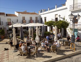 People and cafes in church square plaza, Plaza de la Iglesia, Frigiliana, Axarquia, Andalusia,