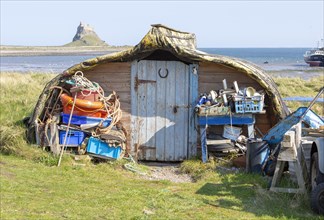 Old upturned boat used as store shed for fishing equipment, Holy Island, Lindisfarne,