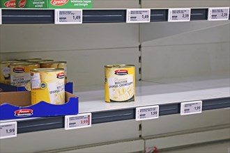 Empty shelf of tins in a supermarket in Germany