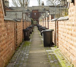 Rubbish refuse bins in back alley of terraced houses in Railway Village, Swindon, Wiltshire,