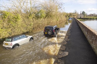 Land Rover Discovery Td5 vehicle driving through flood water at Kellaways, Wiltshire, England, UK