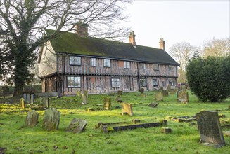 Historic medieval building Fox and Goose pub and church gravestones, Fressingfield, Suffolk,