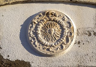 Stone or plasterwork image of the sub set in a wall, Mijas pueblo, Malaga province, Andalusia,