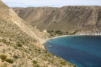 Castle, buildings and beach Cala de San Pedro, Cabo de Gata Natural Park, Nijar, Almeria, Spain,