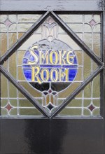 Close-up of stained glass window old vintage pub sign for Smoke Room, The Parrot public house,