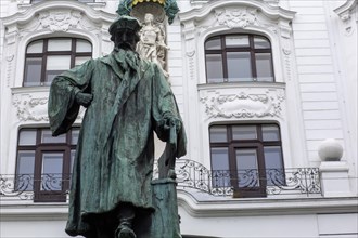 A statue of printing press inventor Gutenberg on a cold winter's day