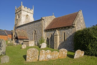 Village parish church of Saint Nicholas, Fyfield, Wiltshire, England, UK weathered gravestones in
