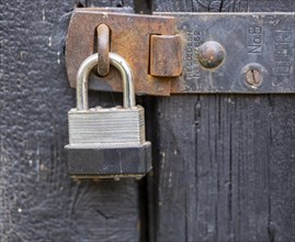 Macro close up of padlock securing door shut securely