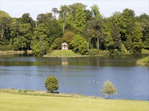 Doric temple and lake, Bowood House and gardens, Calne, Wiltshire, England, UK