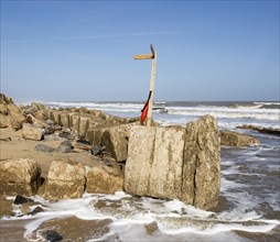 March 20 2018 Hemsby, UK. Coast path sign left abandoned by coastal erosion at Hemsby, Norfolk,