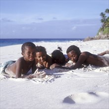 Seychelles, Fregate, local children on the white sandy beach of Anse Victorin, Africa