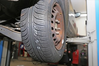 Fitting new all-weather tyres in the garage (editorial)