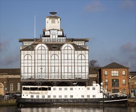 Modern glass office building and Mariners floating restaurant boat, Ipswich Wet Dock, Suffolk,