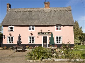 Thatched historic country pub building, The Crown, Bedfield, Suffolk, England, UK pink wash