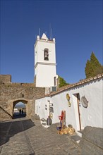 Whitewashed tower and gateway to historic walled hilltop village Monsaraz, Alto Alentejo, Portugal,