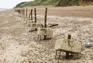 Remains of steel stanchions for barbed wire anti-invasion defences on beach at Bawdsey, Suffolk,