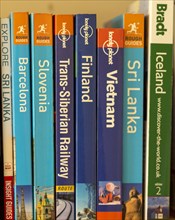 Close up of various travel guide books published by Lonely Planet, Rough Guides, Brandt