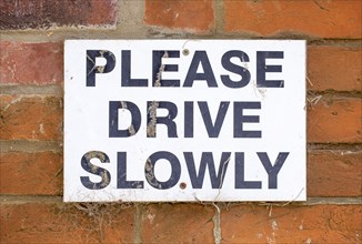 Macro close up sign Please Drive Slowly, UK