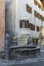 Wooden fountain, house with sgraffito, facade decorations, historic houses, Guarda, Engadin,