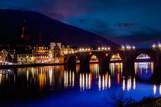 Night shot of Heidelberg. In December 2022, the Old Bridge is unlit with the exception of the