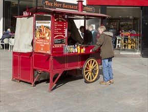 The Hot Sausage Company cart stall in High Street, Exeter city centre, Devon, England, UK
