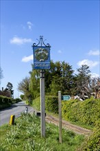 Village sign against blue sky with copy space, Shottisham, Suffolk, England, UK