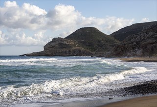 Waves breaking on sandy beach at Las Negras, Cabo de Gata Natural Park, Nijar, Almeria, Spain,