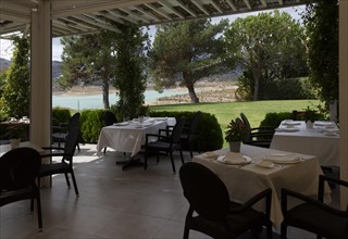 Outdoor dining terrace tables and chairs, Hotel La Vinuela, Axarquia, Andalusia, Spain with view of